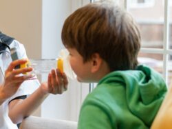 Boy using asthma inhaler