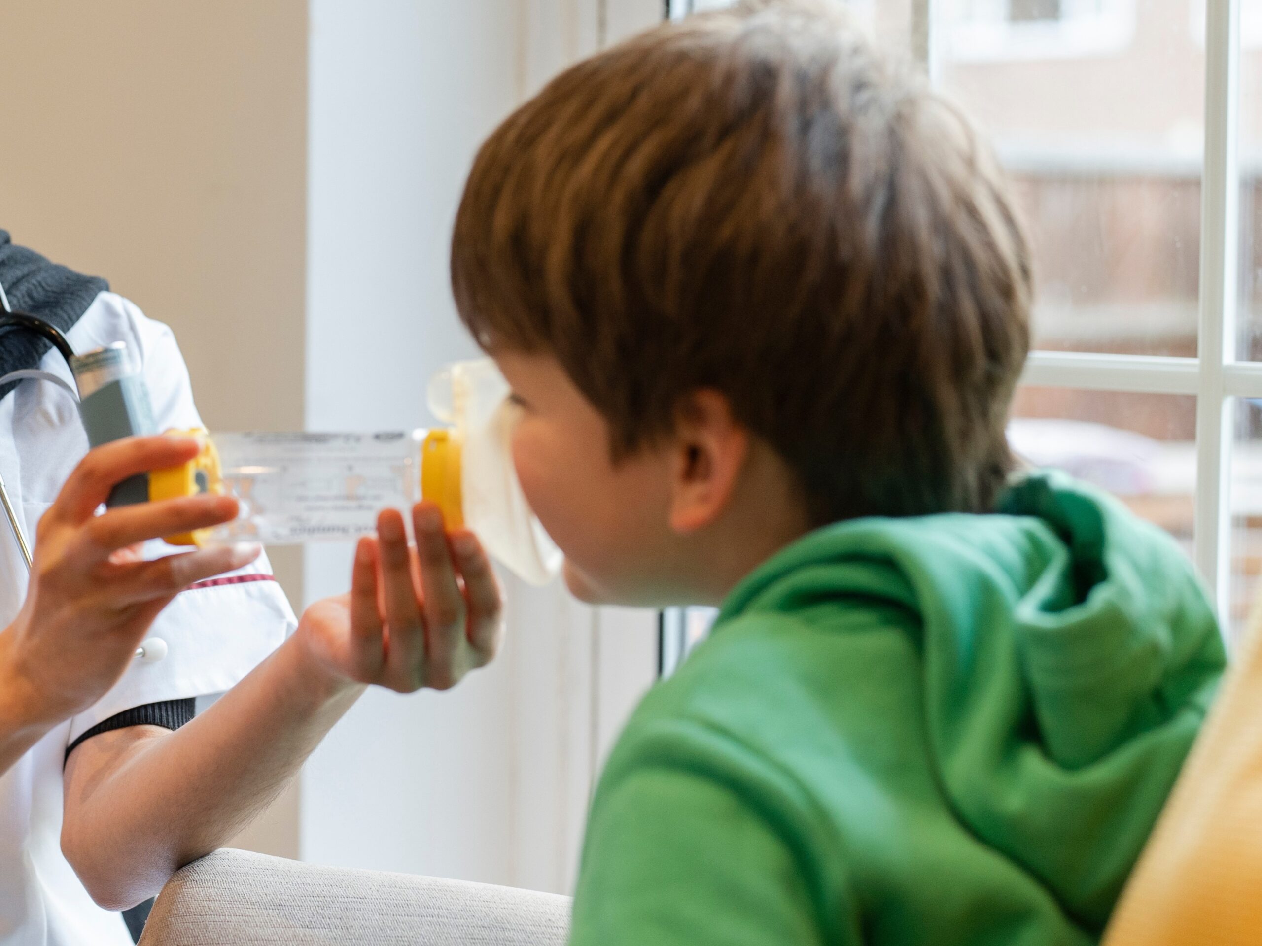 Boy using asthma inhaler